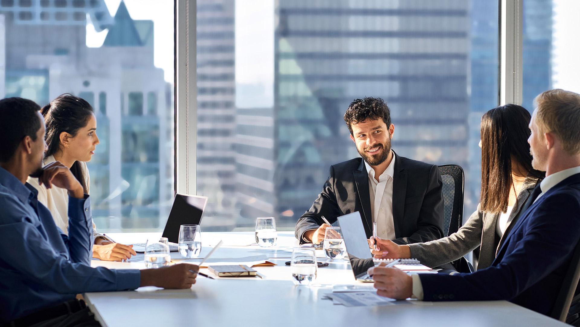 Executive boardroom overlooking a city skyline at night
